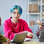 Adult learners in a classroom working on laptops during an AI content creation course in Singapore