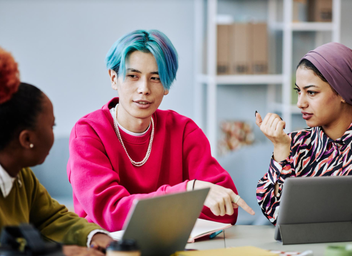 Adult learners in a classroom working on laptops during an AI content creation course in Singapore