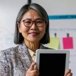 Learner comparing AI content creation course options with a checklist and laptop at a desk
