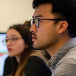HR manager and team lead planning team AI skills training schedule at a meeting table in Singapore