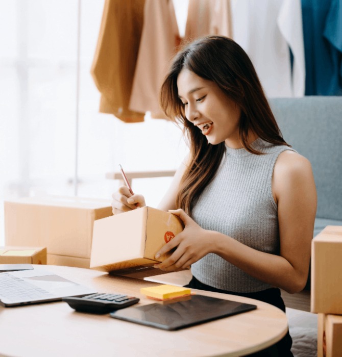 Singapore SME owner packing orders from her online store
